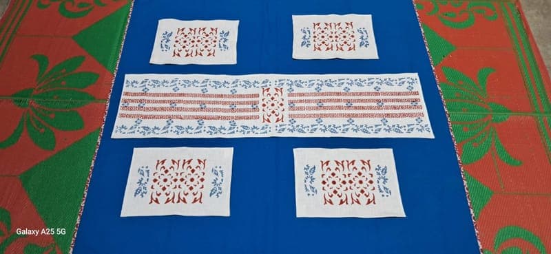 Table linen set in indigo and white block prints: runner, placemats and napkins laid out