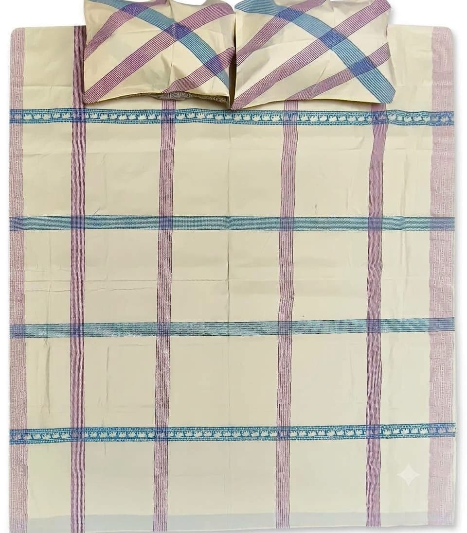 Checked bedspread laid flat with block-printed border