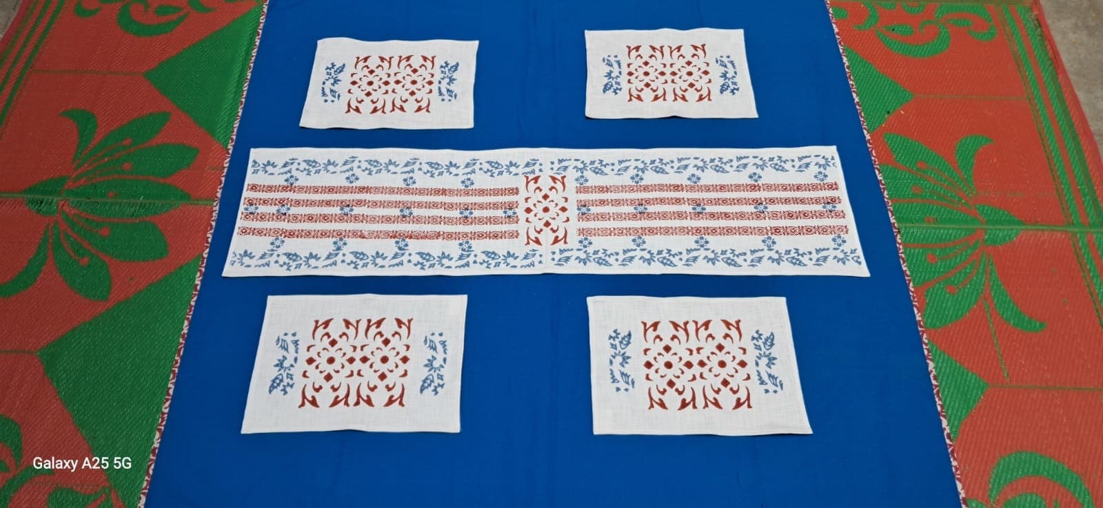 Table linen set in indigo and white block prints: runner, placemats and napkins laid out