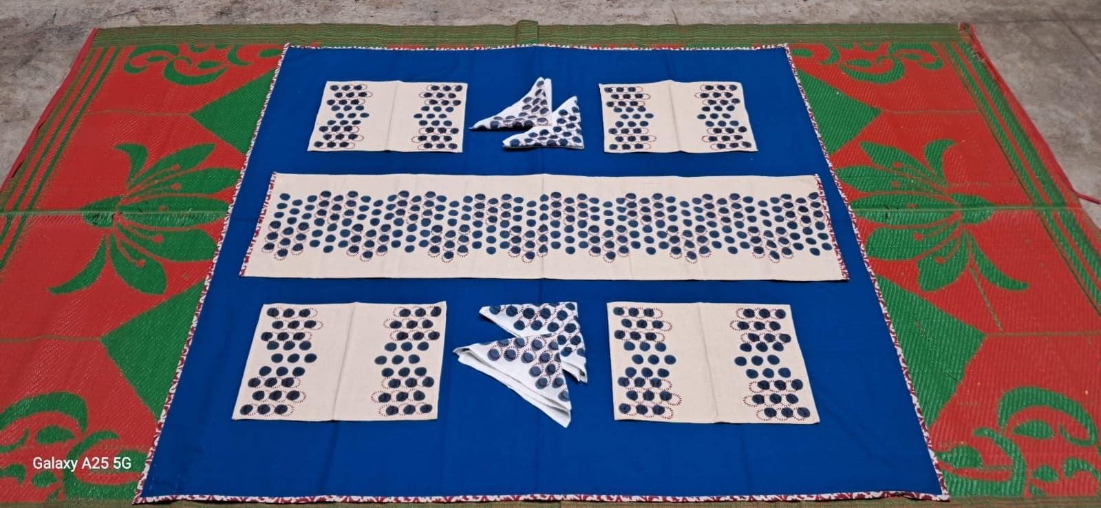 Table linen set in black and white dot-grid block prints with folded napkins