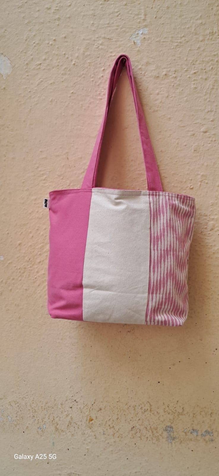 Small colour-block tote in pink and cream with a candy stripe panel