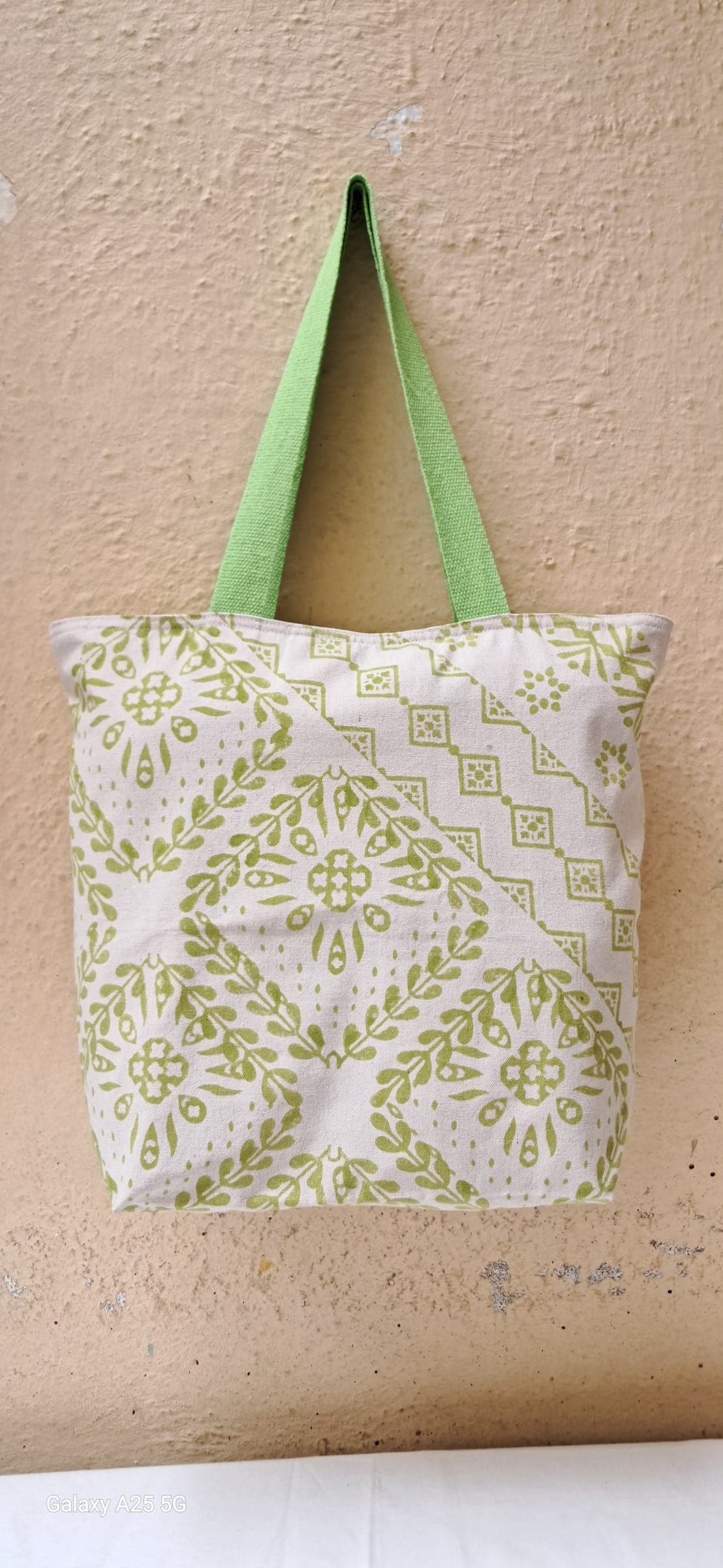 Cotton tote with a green kasuti-style diamond motif block print and green handles