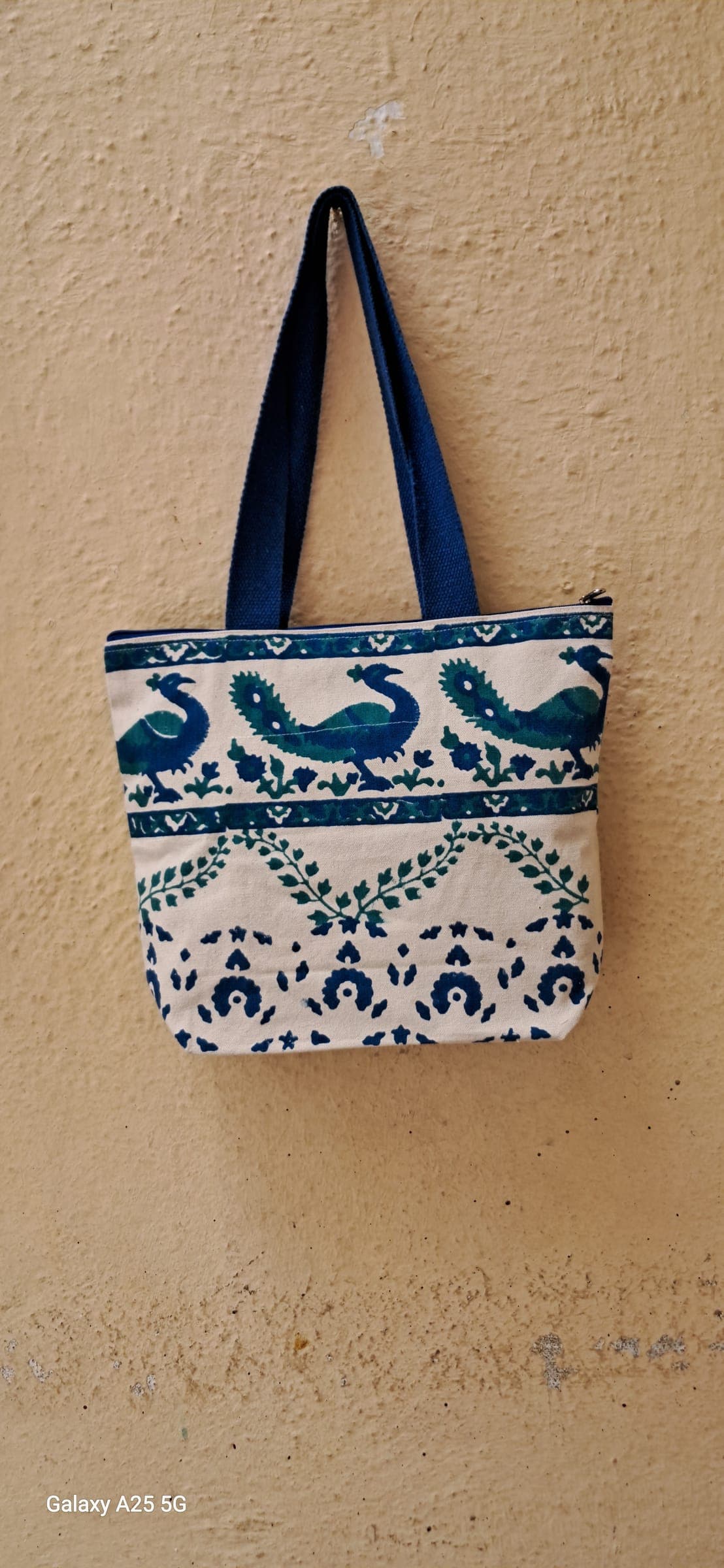 Cotton tote block-printed with rows of blue birds and vines, navy handles