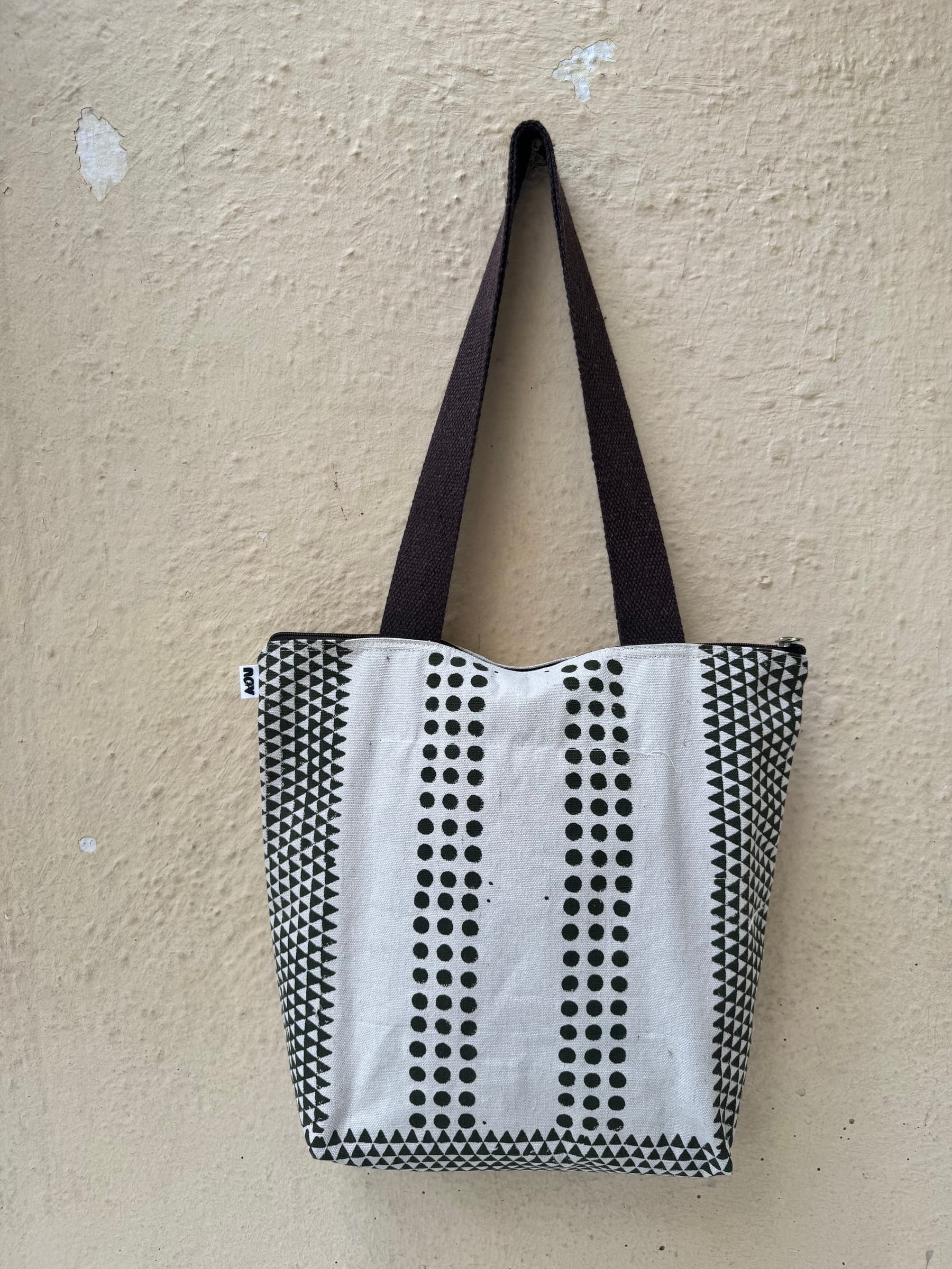 Cotton tote printed with purple lotus pond motifs, purple trim and handles