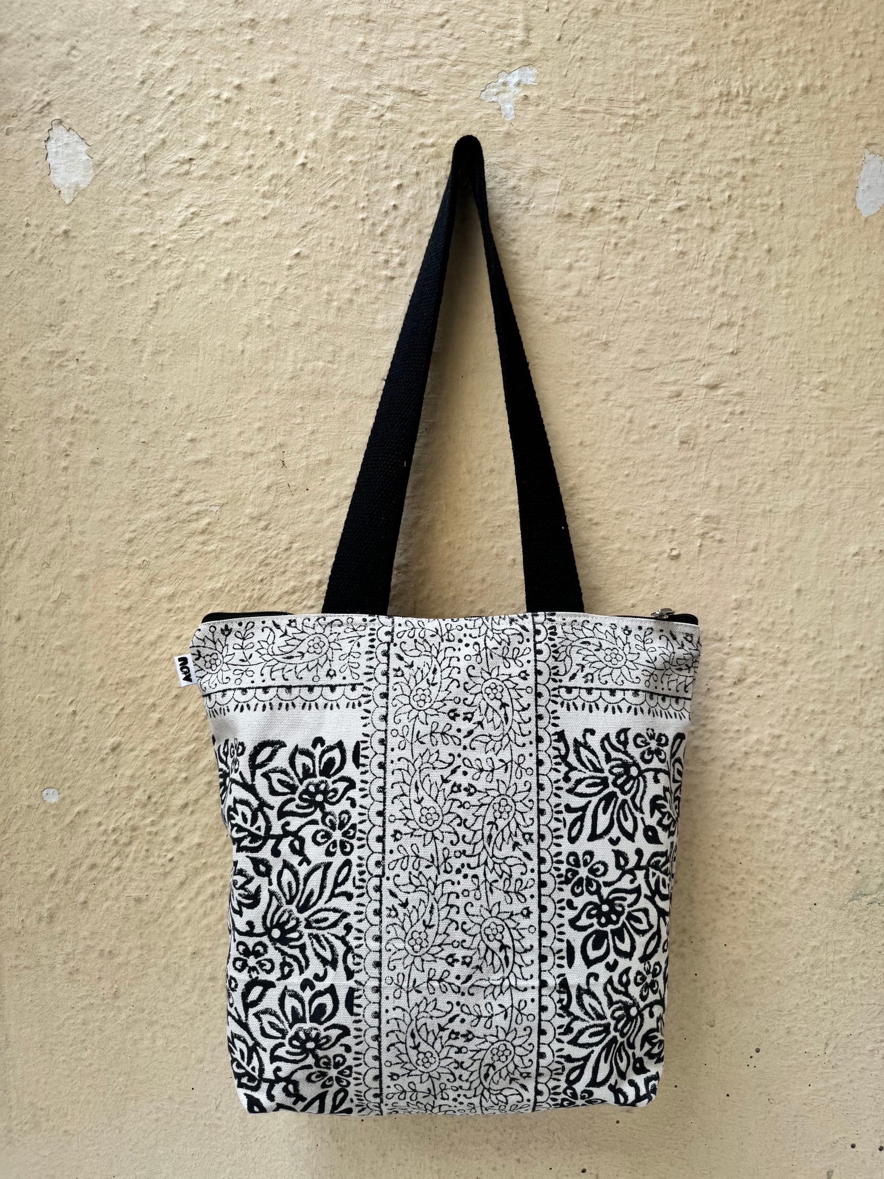 Cotton tote in dense black and white floral column block prints, black handles