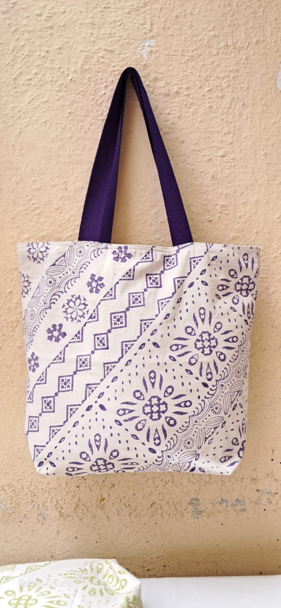 Cotton tote with lilac mandala and zigzag block prints meeting on the diagonal, purple handles