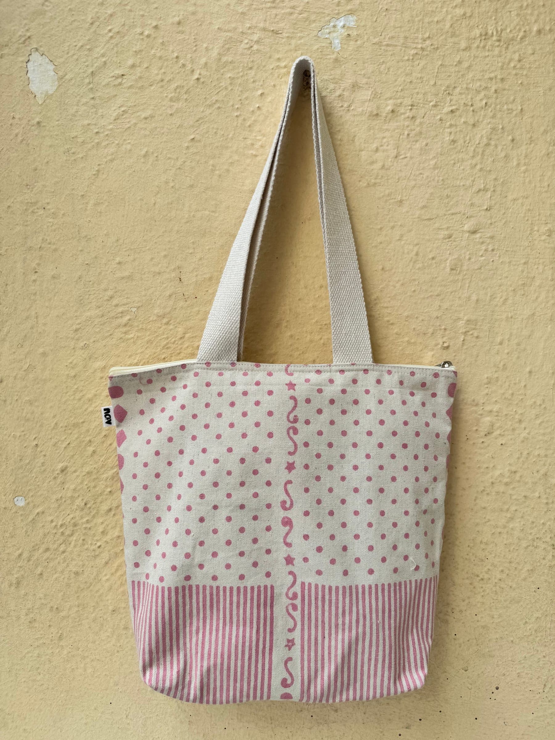 Cotton tote in pink polka dots with a striped base and a printed vine border