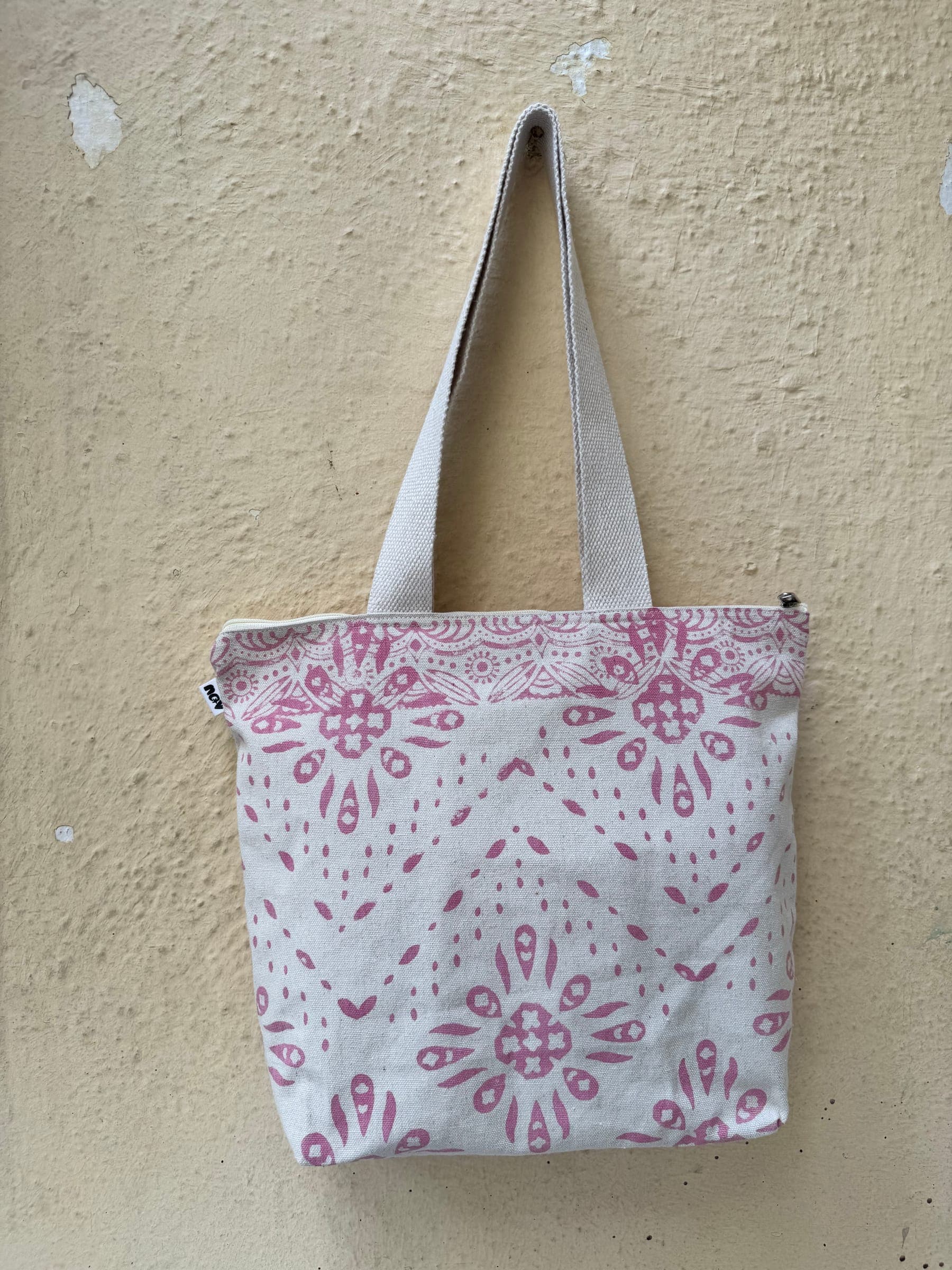 Cotton tote in a soft pink mandala and chevron block print on white